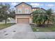 Two-story home featuring a two-car garage, manicured lawn and well-maintained landscaping at 1894 Valley Forge Dr, St Cloud, FL 34769