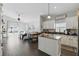 Open kitchen featuring granite countertops, white cabinets and an island, connecting to the living area at 1894 Valley Forge Dr, St Cloud, FL 34769