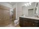 Modern bathroom featuring a glass-enclosed shower and granite vanity at 1909 Nice Ct, Kissimmee, FL 34747