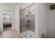 Bathroom featuring glass enclosed shower, tile surround, and view into the bedroom at 1909 Nice Ct, Kissimmee, FL 34747