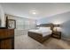 Well lit bedroom features king bed, wood furnishings, and natural light from two large windows at 1909 Nice Ct, Kissimmee, FL 34747