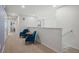 Hallway with seating, two blue velvet chairs, small round table, carpeted floor, and white walls at 1909 Nice Ct, Kissimmee, FL 34747