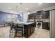 Modern kitchen with an island, dark cabinets, granite countertops, and stainless steel appliances at 1909 Nice Ct, Kissimmee, FL 34747