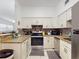 Well-lit kitchen featuring granite countertops, modern appliances, and abundant cabinet space at 1921 N Forsyth Rd, Orlando, FL 32807