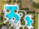 Overhead view of a stunning pool complex with multiple pools, lush landscaping, and lounging areas at 2108 Antilles Club Dr, Kissimmee, FL 34747