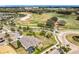 Scenic aerial view of a house adjacent to a golf course with lush landscaping and neighborhood streets at 2108 Antilles Club Dr, Kissimmee, FL 34747