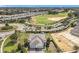 Aerial view of home featuring a three car garage, situated near a golf course and new construction at 2108 Antilles Club Dr, Kissimmee, FL 34747