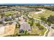 Aerial view of a home with a golf course nearby, set within a well-maintained, suburban community at 2108 Antilles Club Dr, Kissimmee, FL 34747