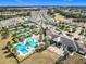 Expansive community pool area with palm trees, clubhouse, and tennis courts, perfect for recreation at 2108 Antilles Club Dr, Kissimmee, FL 34747