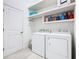 Well-organized laundry room with modern washer and dryer, ample shelving, and a clean, bright atmosphere at 2108 Antilles Club Dr, Kissimmee, FL 34747