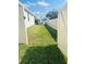 A backyard with a white fence, lush green grass and an above ground pool visible in the background at 2199 Bluebird Pl, St Cloud, FL 34771