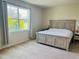 Tranquil bedroom featuring neutral decor, large window, and a comfortable bed at 2199 Bluebird Pl, St Cloud, FL 34771