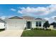 Charming single-story home with a well-manicured lawn and attached two-car garage at 2199 Bluebird Pl, St Cloud, FL 34771