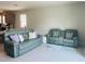 Comfortable living room with plush seating, neutral tones, and tile flooring at 2199 Bluebird Pl, St Cloud, FL 34771