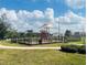 Community playground area with slides and a shaded structure at 2199 Bluebird Pl, St Cloud, FL 34771