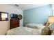 This bedroom features two twin beds, blue accent wall, and a window at 2292 Crofton Ave, Davenport, FL 33837