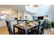 Bright dining room features a dark wood table set for six, with a view into the modern kitchen at 2292 Crofton Ave, Davenport, FL 33837