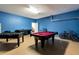 Spacious game room featuring a pool table, foosball table, and painted blue walls at 2292 Crofton Ave, Davenport, FL 33837