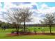 Manicured golf course with mature trees and lush greenery, showcasing the property's outdoor amenities at 2292 Crofton Ave, Davenport, FL 33837