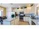 Bright kitchen featuring white cabinetry, granite countertops, stainless steel appliances and island at 2292 Crofton Ave, Davenport, FL 33837