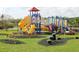 Community playground featuring a colorful array of slides, climbing structures, and play equipment for enjoyment at 2292 Crofton Ave, Davenport, FL 33837