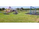 Spacious community playground with multiple play structures, swings, and lush green surroundings for outdoor fun at 2292 Crofton Ave, Davenport, FL 33837