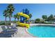 Poolside slide and lounge chairs with lush tropical landscaping and palm trees at 2292 Crofton Ave, Davenport, FL 33837