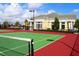 A community tennis court is shown in the foreground with the community center in the background at 2292 Crofton Ave, Davenport, FL 33837