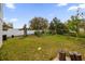 Large backyard with a partial fence and ample greenery at 241 Cranbrook Dr, Kissimmee, FL 34758