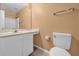 Cozy bathroom with white vanity, toilet, and tile flooring at 241 Cranbrook Dr, Kissimmee, FL 34758