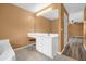 Bathroom vanity with a large mirror, white cabinets and tiled floor at 241 Cranbrook Dr, Kissimmee, FL 34758