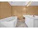 Bathroom with a tiled floor, soaking tub and vanity at 241 Cranbrook Dr, Kissimmee, FL 34758