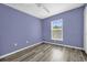 A bright bedroom with modern wood-look flooring and a ceiling fan at 241 Cranbrook Dr, Kissimmee, FL 34758