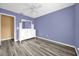 Bright bedroom with modern wood-look flooring and white dresser at 241 Cranbrook Dr, Kissimmee, FL 34758