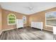 Bright bedroom with modern gray flooring, ceiling fan, and dual dressers at 241 Cranbrook Dr, Kissimmee, FL 34758