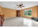 Primary bedroom with tile flooring, ceiling fan, and a large window providing natural light at 241 Cranbrook Dr, Kissimmee, FL 34758