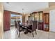 Dining room featuring tile flooring, elegant chandelier, and built-in display cabinets at 241 Cranbrook Dr, Kissimmee, FL 34758