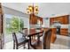 Cozy eat-in kitchen with wood cabinetry, marble countertops, and a sliding glass door to backyard at 241 Cranbrook Dr, Kissimmee, FL 34758