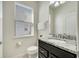 Powder room featuring granite counters, dark cabinets, and a toilet at 2471 Dubai St, Kissimmee, FL 34747