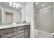 Modern bathroom with granite countertops, dual sinks, and a glass-enclosed shower at 2471 Dubai St, Kissimmee, FL 34747