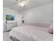 Bright bedroom featuring a ceiling fan, dresser, and mounted TV for entertainment at 2471 Dubai St, Kissimmee, FL 34747