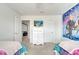 Shared bedroom with cartoon mural, two twin beds, and access to the media room at 2471 Dubai St, Kissimmee, FL 34747