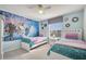 Charming bedroom with cartoon themed mural, two twin beds, and light blue walls at 2471 Dubai St, Kissimmee, FL 34747