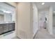 Hallway view into a bathroom with granite countertops and a bedroom with a TV at 2471 Dubai St, Kissimmee, FL 34747