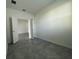 Neutral bedroom with tile flooring, white walls, and an open doorway at 250 Brave Rd, Davenport, FL 33837