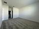 Carpeted primary bedroom with walk-in closet and door leading to bathroom at 250 Brave Rd, Davenport, FL 33837