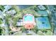 Aerial showcasing community amenities: pool, clubhouse, playground, and tennis courts at 2512 Volta Cir, Kissimmee, FL 34746