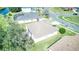 Overhead view of home with large backyard adjacent to community pond with mature trees at 2512 Volta Cir, Kissimmee, FL 34746