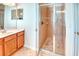 Bathroom with a glass-enclosed shower and a vanity with light wood cabinets at 2512 Volta Cir, Kissimmee, FL 34746