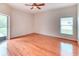 Neutral bedroom features a ceiling fan, wood floors, and sliding glass doors to the porch at 2512 Volta Cir, Kissimmee, FL 34746